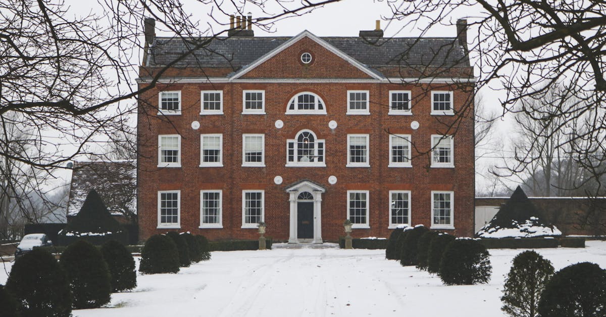 Elegant-brick-mansion-set-in-a-snowy-winter-scene-with-classic-architectural-details-and-stately-symmetry